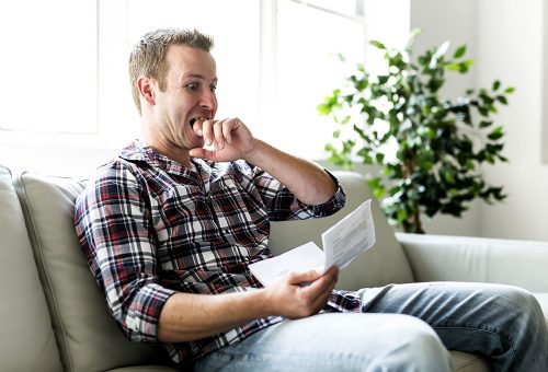 Person reading letter looking shocked