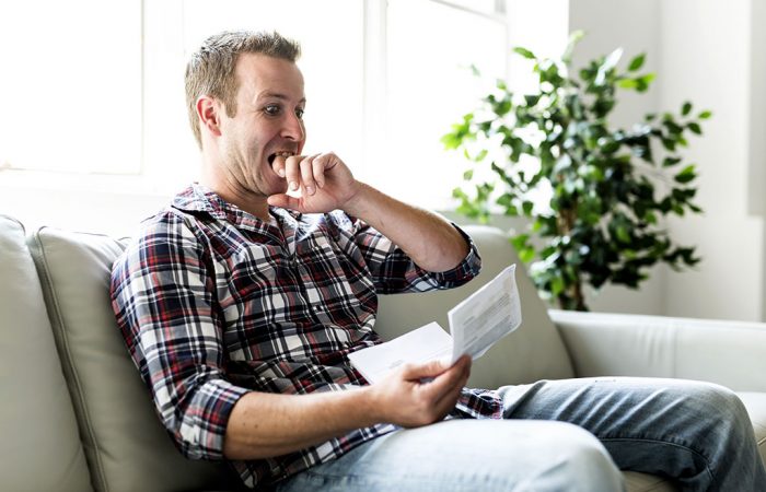 Person reading letter looking shocked