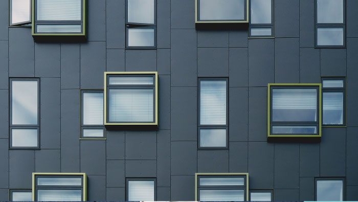 Windows on a grey tiled wall