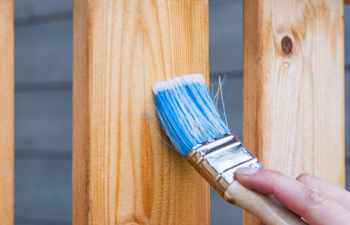 Paintbrush being used on wood